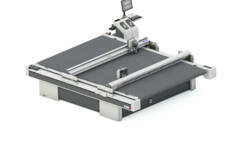 Zünd D3 2XL digital cutting system with a large, dark grey cutting surface and integrated control panel. Zünd D3 2XL digital cutting system with a large, dark grey cutting surface and integrated control panel.
