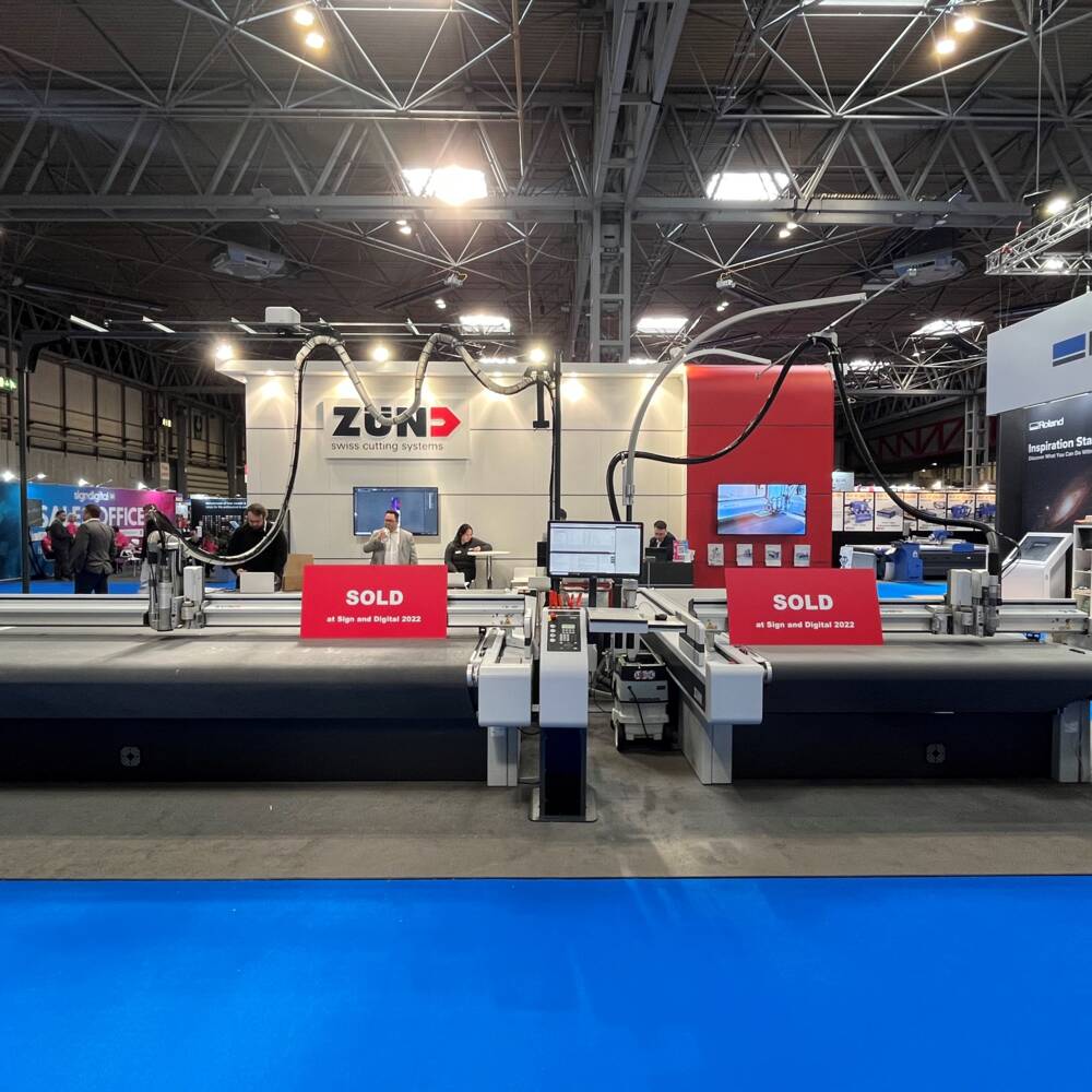 Zünd cutting system on display at Sign and Digital 2022, with 'SOLD' signs indicating successful sales. Zünd cutting system on display at Sign and Digital 2022, with 'SOLD' signs indicating successful sales.